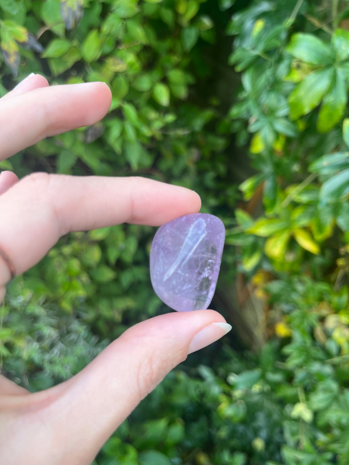 Amethyst spiritual Healing crystal tumblestone in hand